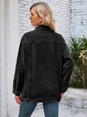 Black oversized denim trucker jacket with button details and rolled sleeves.