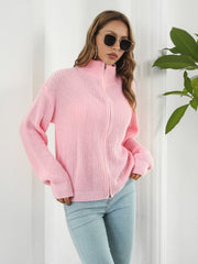 Blush pink ribbed knit zip-up sweater with a mock neck and full zip closure.