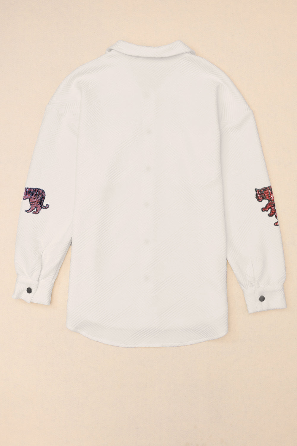 White quilted overshirt with embroidered tiger detail on sleeves.