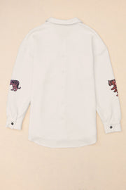 White quilted overshirt with embroidered tiger detail on sleeves.