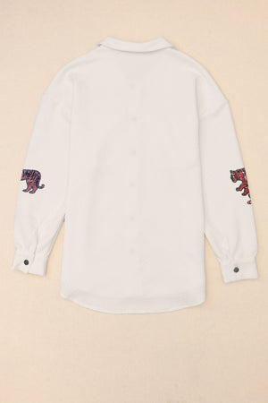 White quilted overshirt with embroidered tiger detail on sleeves.