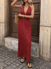 Burgundy polka dot maxi dress with halter neck and deep V-neck.