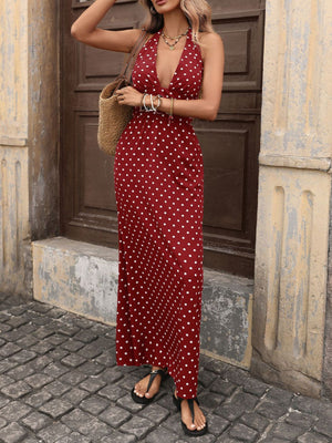Burgundy polka dot maxi dress with halter neck and deep V-neck.