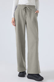 Relaxed palazzo sweatpants in sage with drawstring waist and pockets.