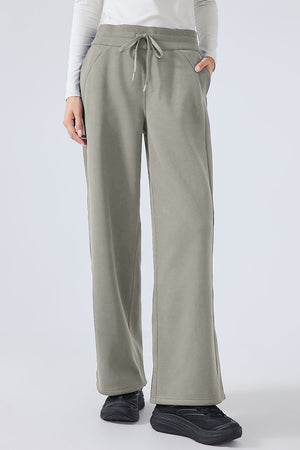 Relaxed palazzo sweatpants in sage with drawstring waist and pockets.