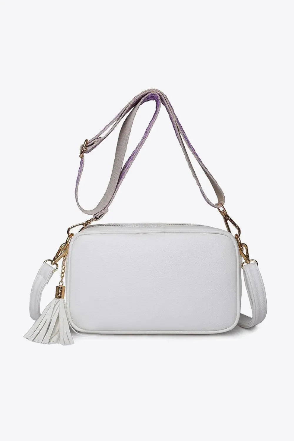 White textured crossbody bag with tassel detail and purple-accented strap