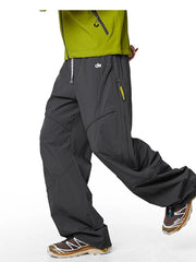 Graphite gray relaxed fit cargo active pants with drawstring and zippered pockets.
