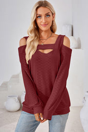 Burgundy geometric cutout shoulder top with long sleeves and a square neckline.