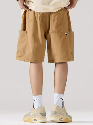 Khaki relaxed fit 100 cotton cargo shorts with adjustable drawstring and multiple pockets.
