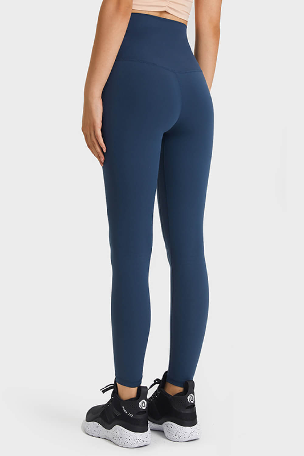 Navy high rise leggings with a seamless V-cut back detail.