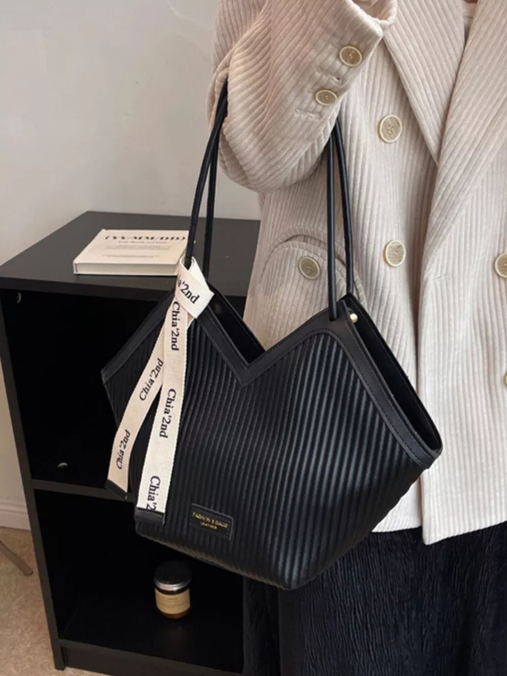 Black ribbed texture large shoulder bag with white logo straps.