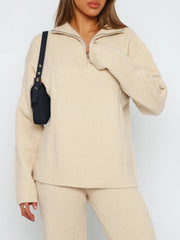 Tan ribbed knit quarter-zip lounge set with a relaxed fit and silver zipper detail.