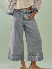 Light blue high-waisted cropped jeans with wide legs and striped cuffs.