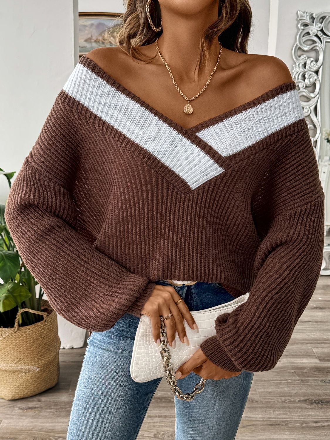 Chocolate off-shoulder knit sweater with contrast trim and V-neck.