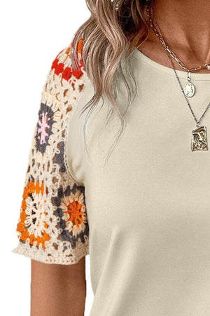 Ivory tee with colorful crochet granny square sleeves.
