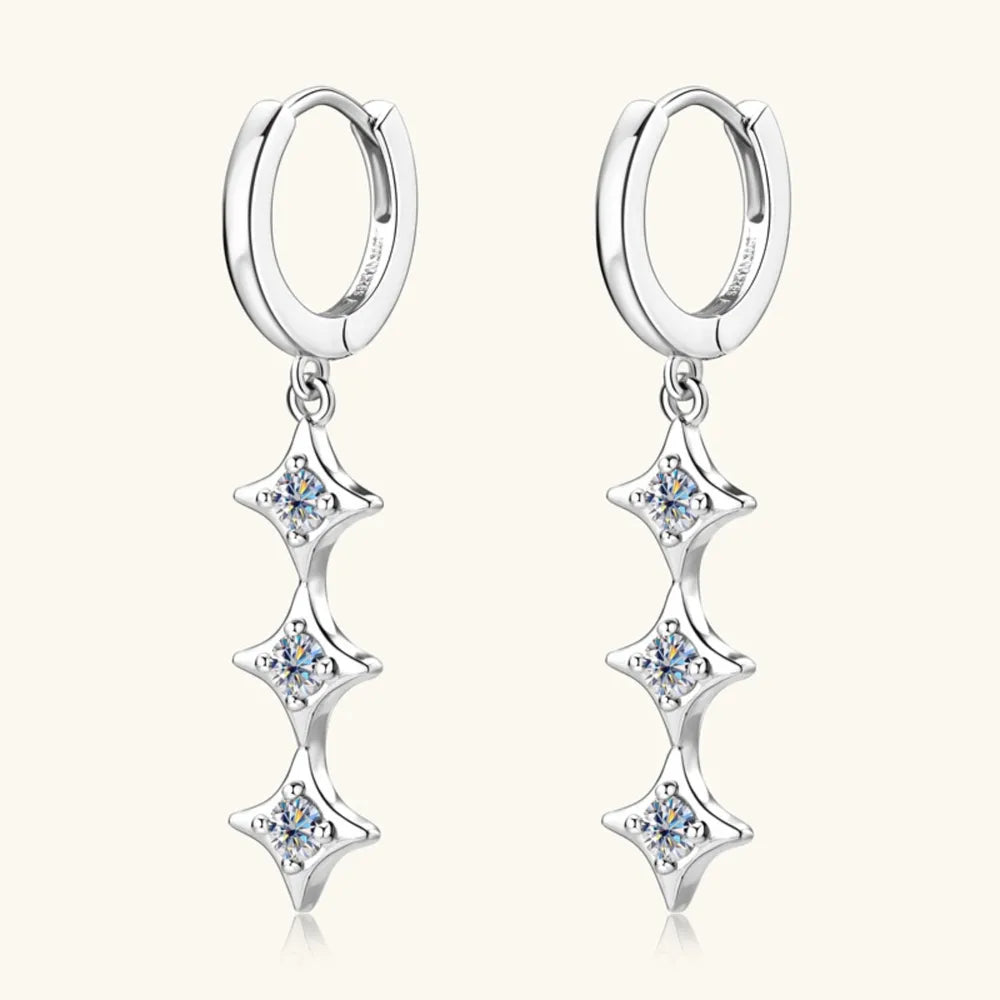 Silver hoop earrings with three cascading star-shaped moissanite charms.