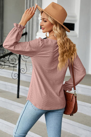 Textured puff sleeve blouse in Dusty Pink with ruffle cuffs and a diamond pattern.