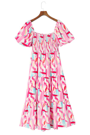 Blush pink midi dress with smocked bodice, puff sleeves, and tiered skirt in a brushstroke print.