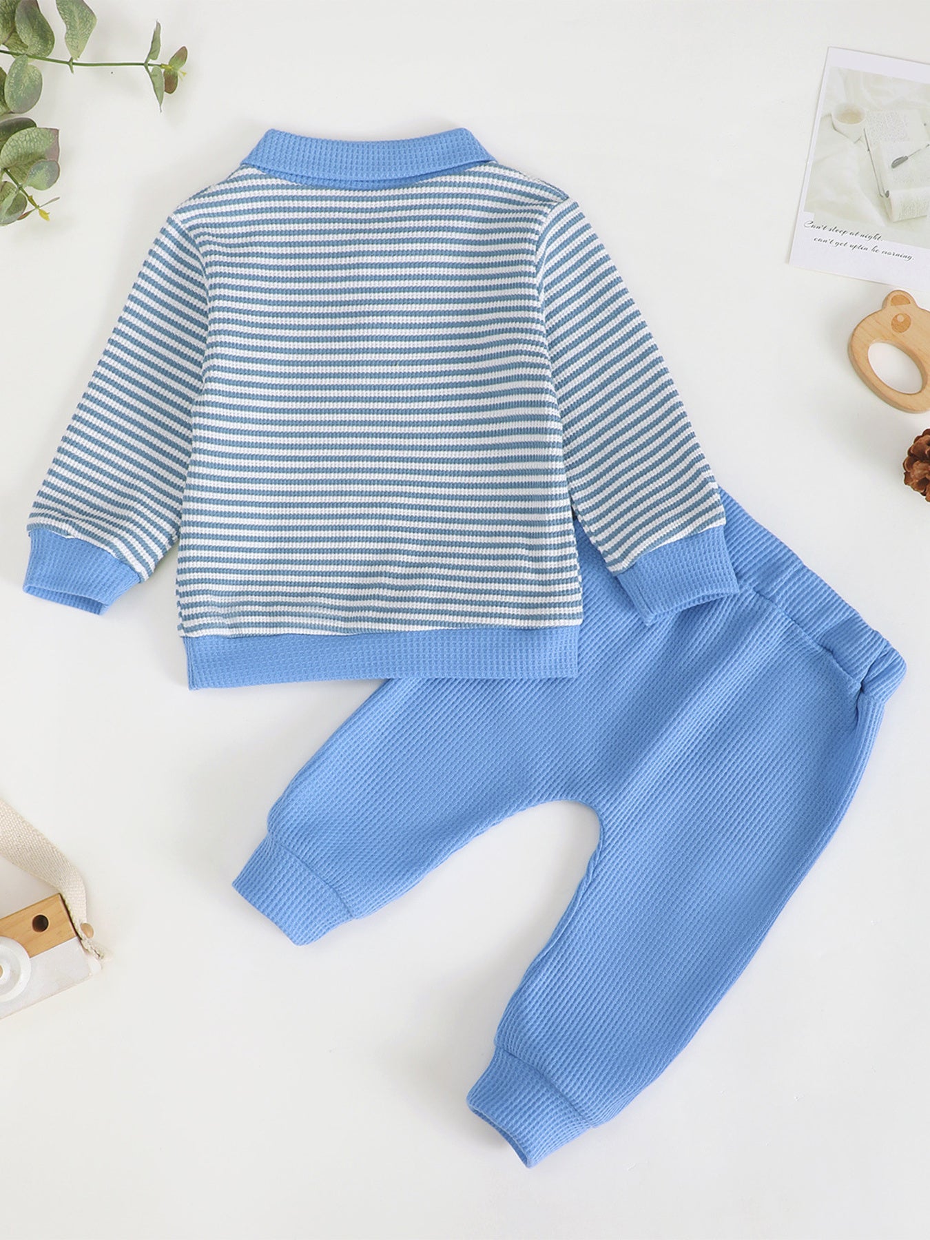 Children's blue and white striped polo shirt with matching waffle knit pants.