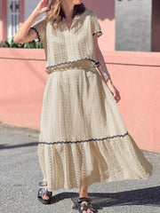Cream crochet co-ord set with scalloped trim and short sleeves.