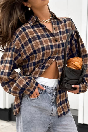 Oversized brown plaid button-up shirt jacket with a collar and buttoned front, styled casually.