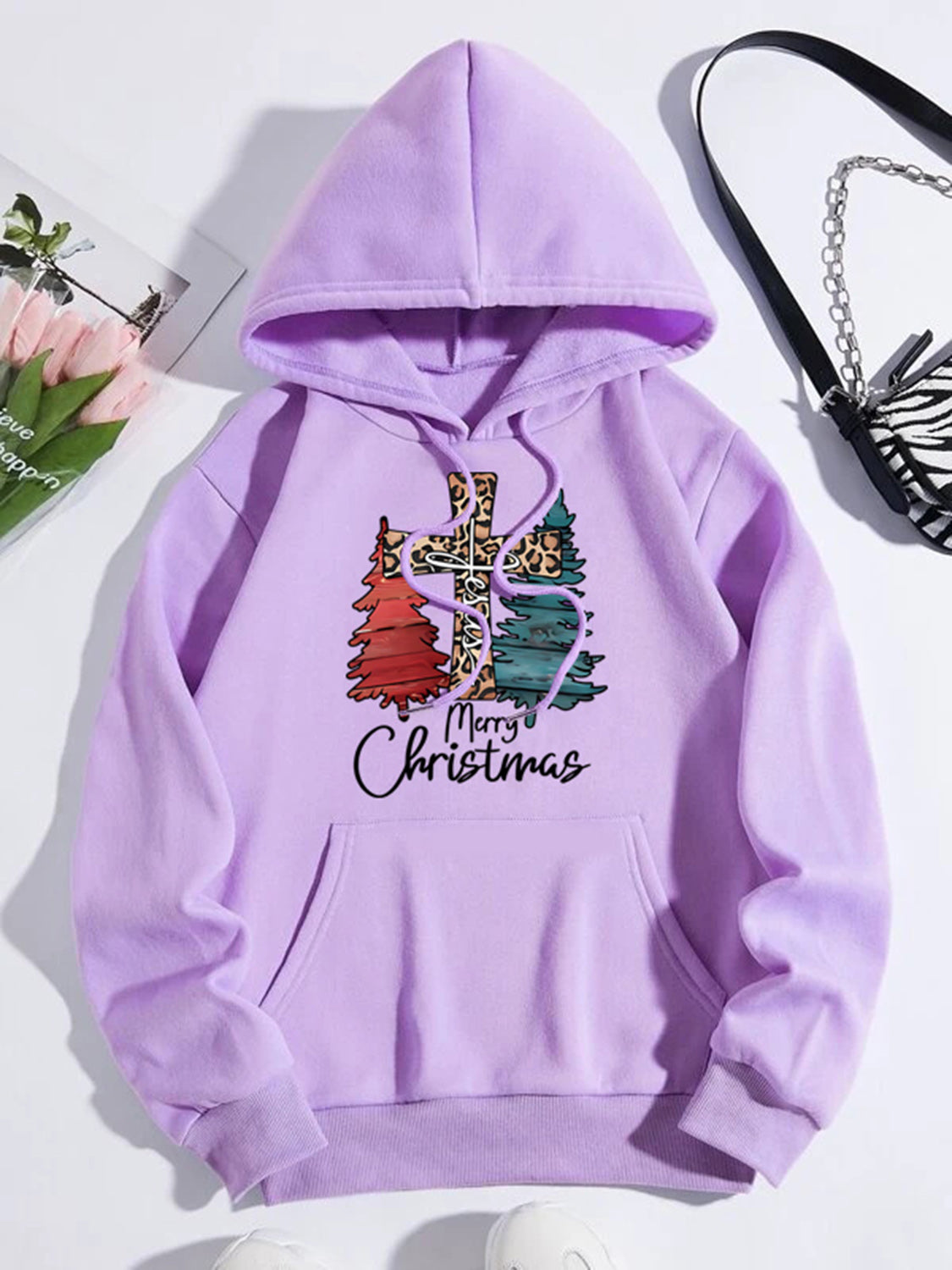 Lilac hoodie with leopard cross and Christmas trees graphic and Merry Christmas text.