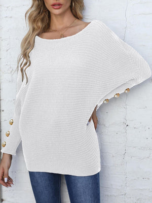 White batwing knit sweater with pearl button cuff detail and boat neckline.