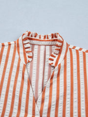 Striped V-neck mini dress with ruffled collar and textured fabric.