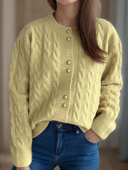Pastel yellow cable knit cardigan with puff sleeves and gold buttons