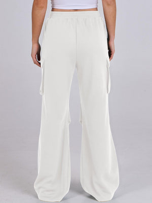White sweatpants with cargo pockets and a wide leg cut.