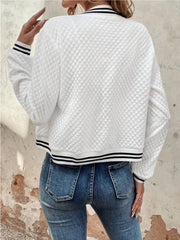 White quilted bomber jacket with black striped ribbing at the collar, cuffs, and hem.