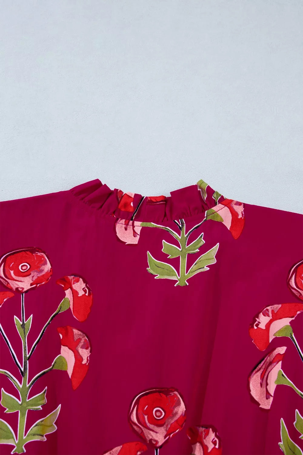 Charming floral tiered midi dress in magenta with a ruffled neckline and red floral print.