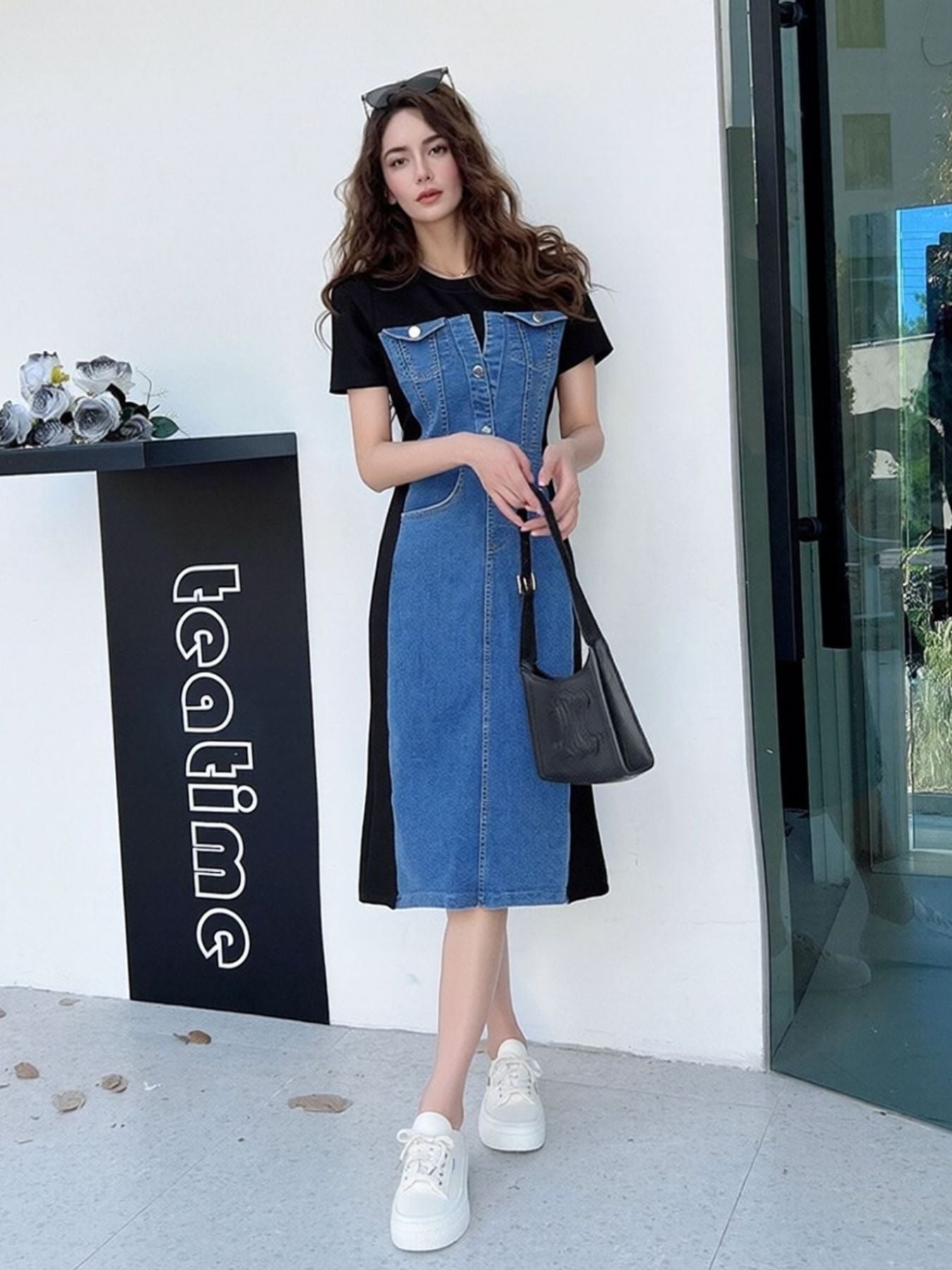 Denim patchwork short-sleeve midi dress with button-down front and contrast black panels.