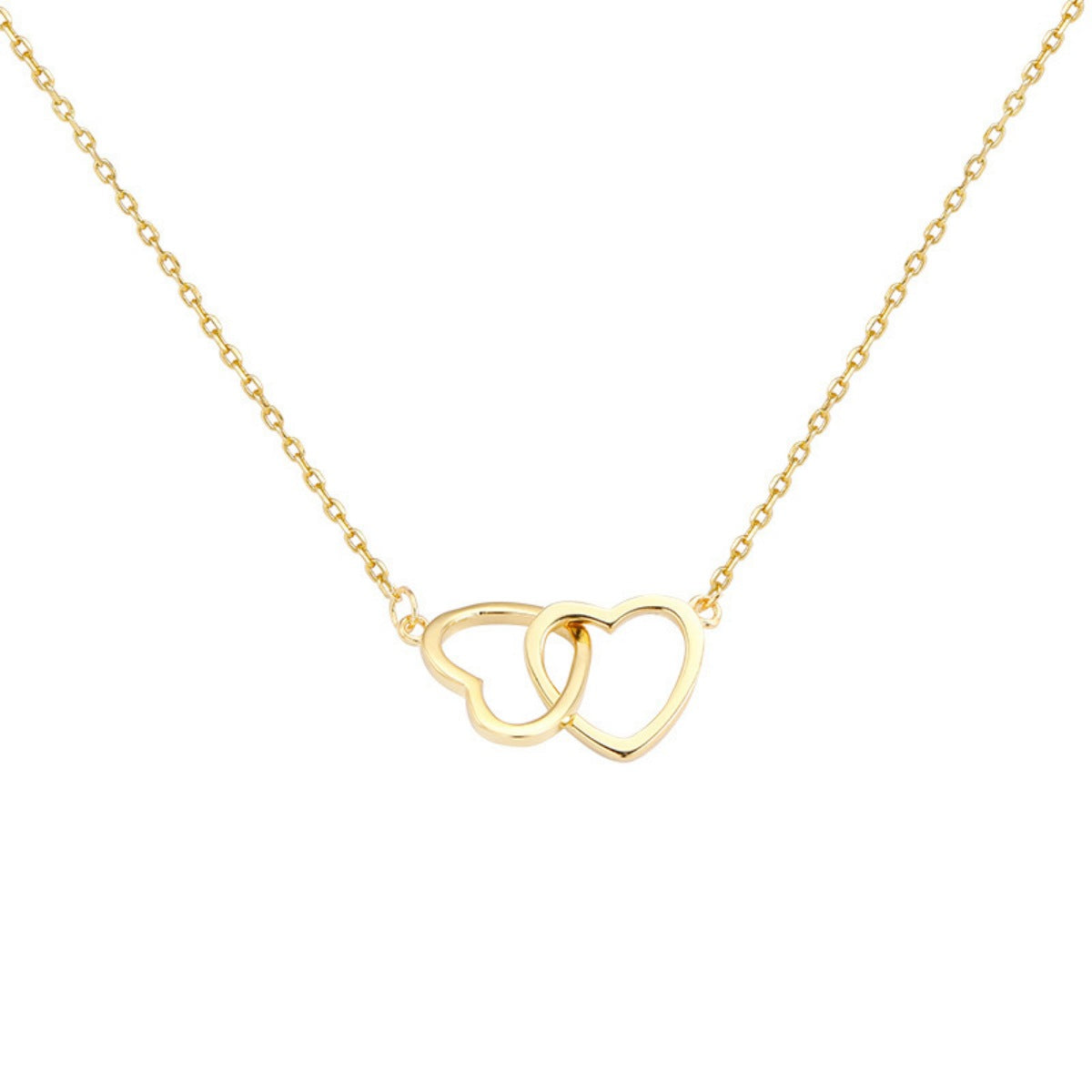 Gold interlocking heart pendant necklace with a delicate chain.