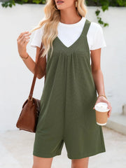 Moss green textured romper with gathered yoke and v-neck, styled with a white tee and brown crossbody bag.