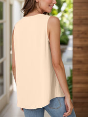 Sleeveless peach blouse with a round neckline and a flowy hem.
