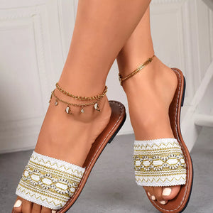 Embroidered artisan open-toe sandals in white with gold detailing and brown soles.