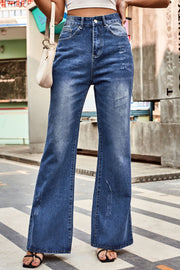 Flared denim jeans in medium blue with subtle distressing and a button fly.