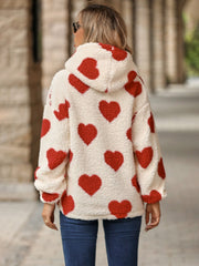 Cream sherpa hoodie with all-over red heart print and hood.