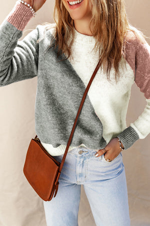 Geometric colorblock knit sweater in white, grey, and pink with a crew neck and long sleeves.