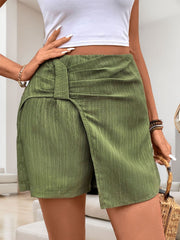 Matcha green skort shorts with draped knot front detail and textured fabric.