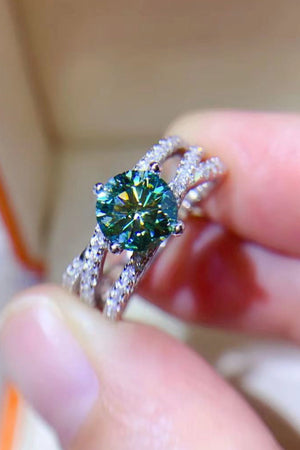 Twisted pavé halo ring with a light green stone and sterling silver band.