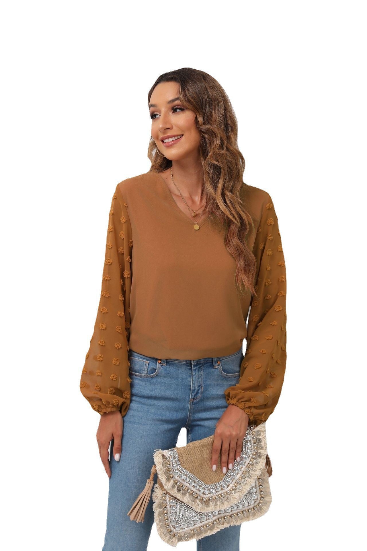 Camel V-neck blouse with textured pom-pom balloon sleeves.
