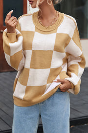 Checkerboard knit relaxed crewneck sweater in tan and white with balloon sleeves.