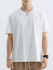 White cotton crew neck t-shirt with short sleeves and a relaxed fit.