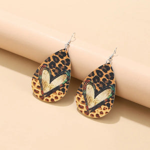 Leopard print heart drop earrings with a distressed finish.