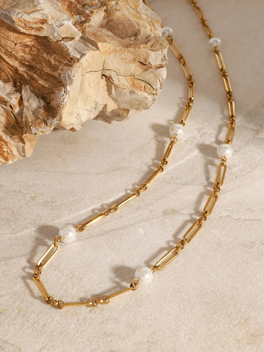 Gold chain necklace with pearl accents and elongated links