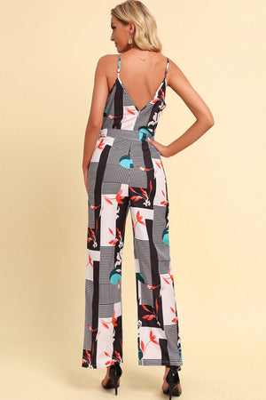 Geometric print cami jumpsuit with tie in white, featuring a V-neck and wide legs.