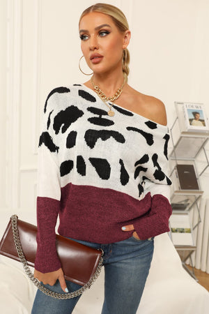 Cow print off-shoulder knit sweater in burgundy and white with black spots, acrylic material, boat neck.