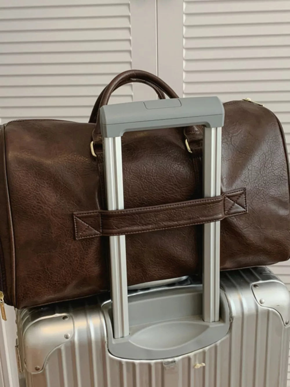 Brown faux leather travel organizer bag with top handles and a detachable strap.